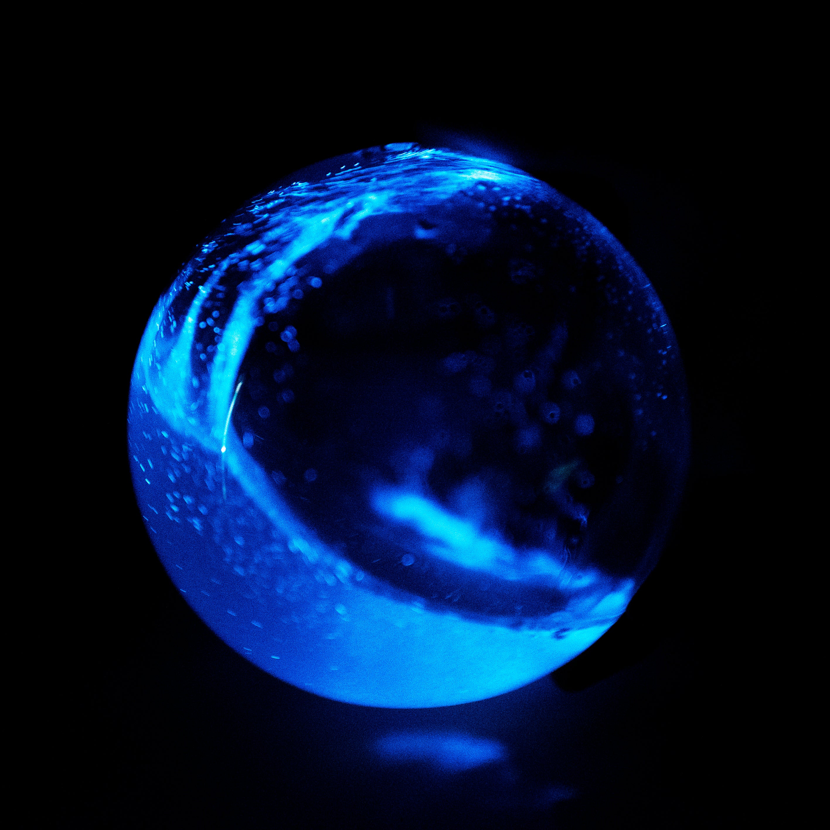 Bio-Orb filled with PyroDinos swirl at night bioluminescence