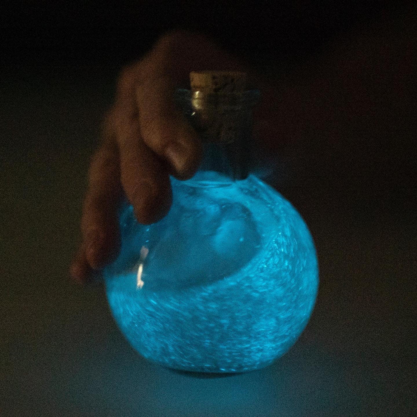 Magic potino bottle nighttime bioluminescent