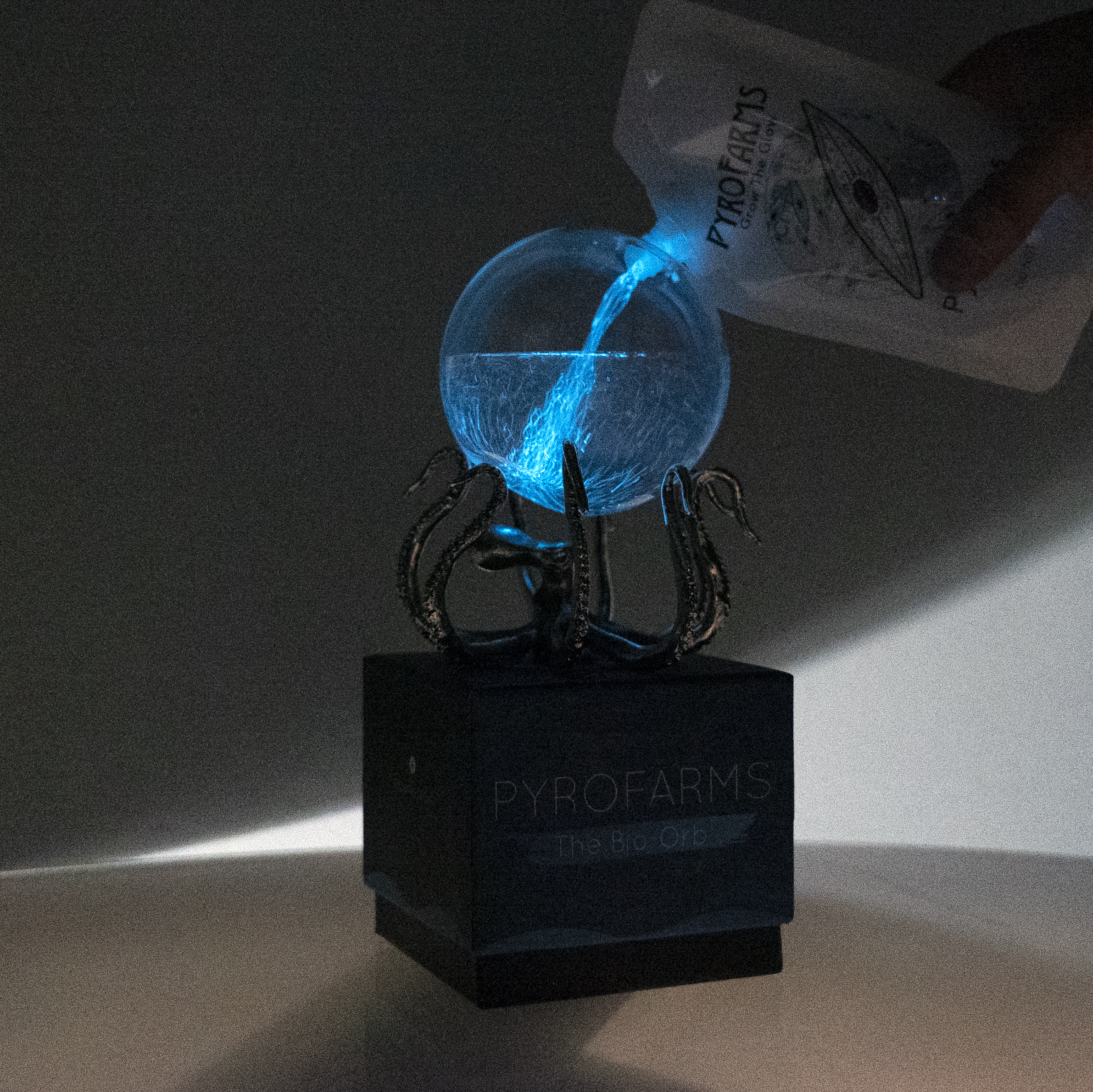 Pouring bioluminescent dinos into Bio-Orb with OctoStand